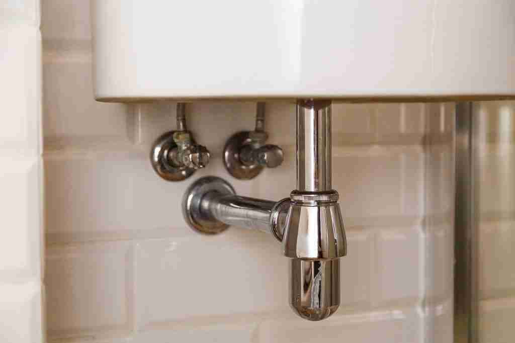 Sink drain in a bathroom, clean.