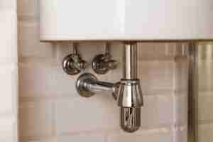 Sink drain in a bathroom, clean.
