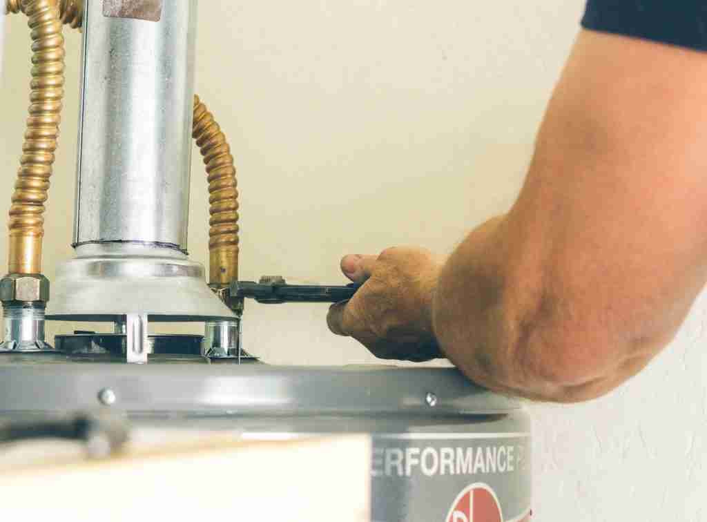 adult male arm with wrench in hand