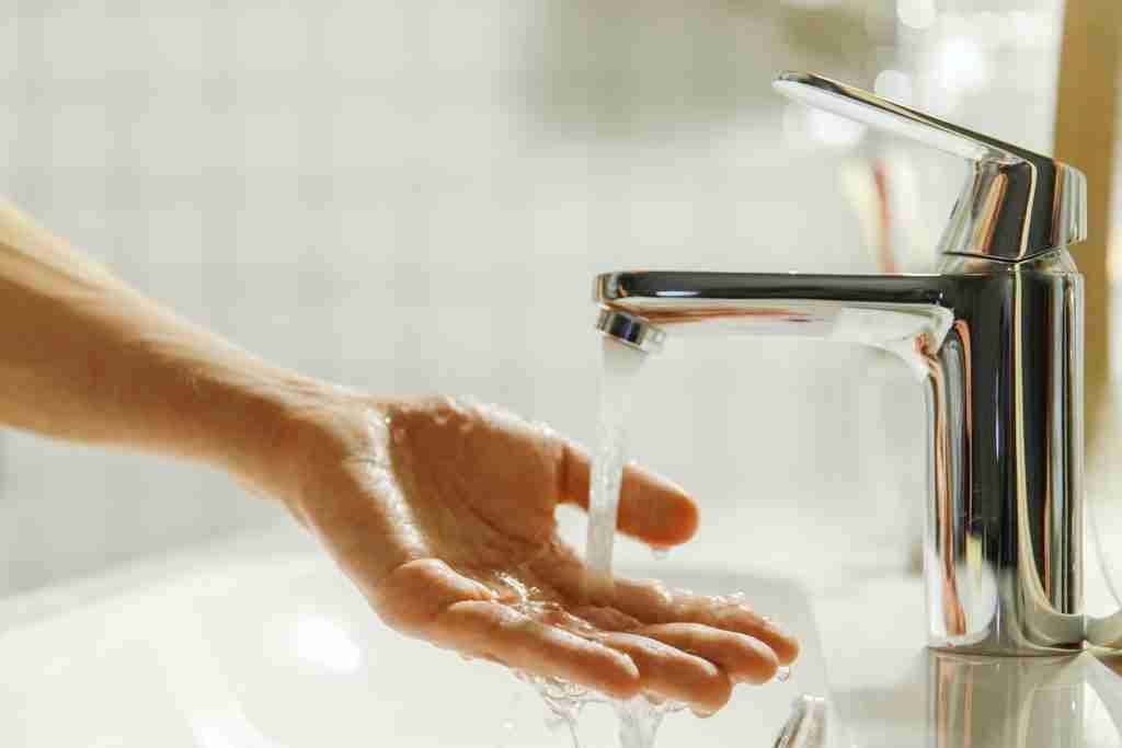 Man washing and cleaning her hand