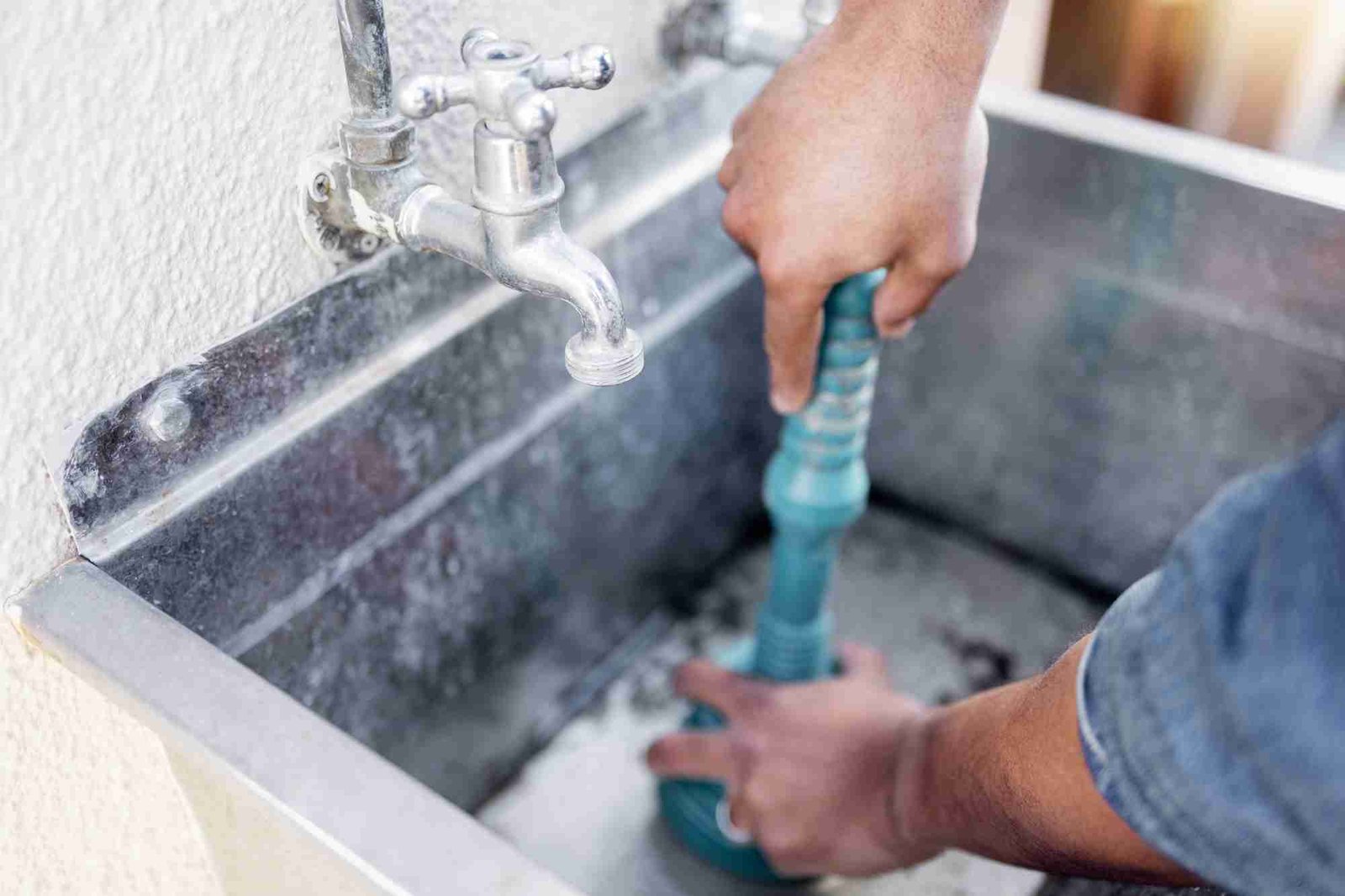 Plumber, drain and man with plunger for sink, maintenance and repairs, blockage or cleaning. Plumbi